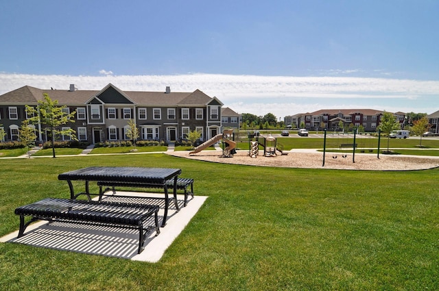 surrounding community with playground community, a residential view, and a yard