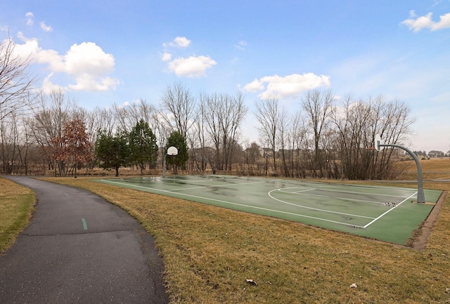 view of basketball court with community basketball court and a lawn