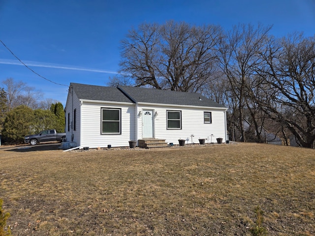 view of front of home featuring a front yard and roof with shingles