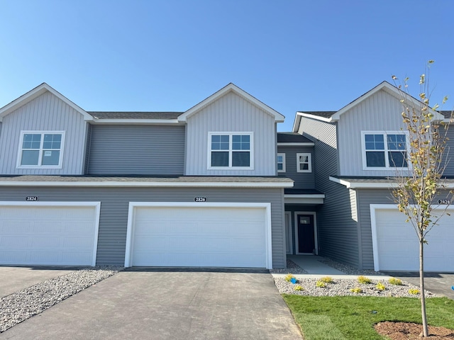 view of front facade featuring board and batten siding, concrete driveway, and an attached garage