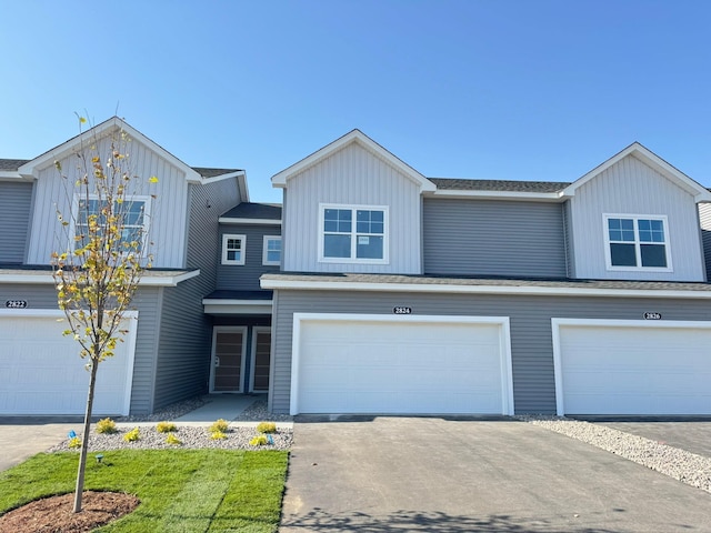 view of front of property featuring an attached garage, driveway, and board and batten siding