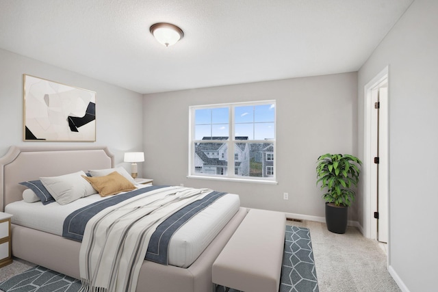 bedroom with carpet flooring, baseboards, and visible vents