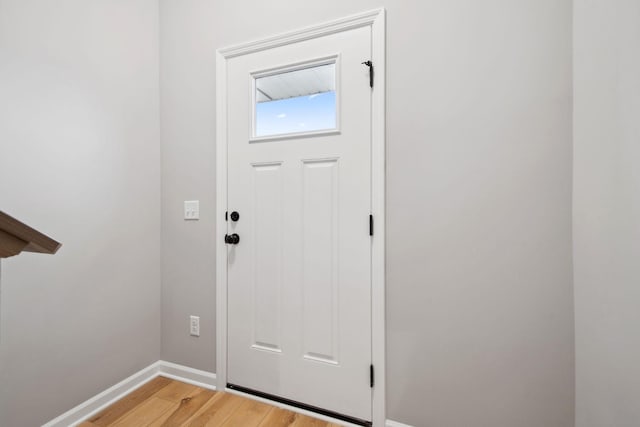 entryway featuring baseboards and light wood-style flooring