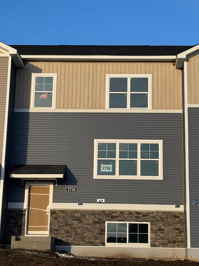 exterior space with stone siding