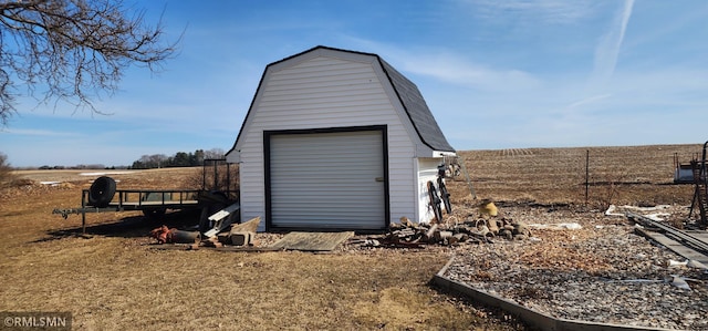 view of shed featuring driveway and fence