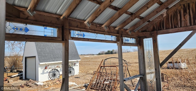 view of yard with a rural view, an outdoor structure, and a shed