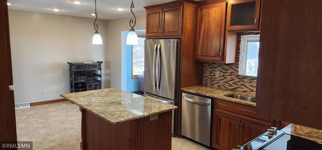 kitchen featuring tasteful backsplash, visible vents, appliances with stainless steel finishes, and light stone counters