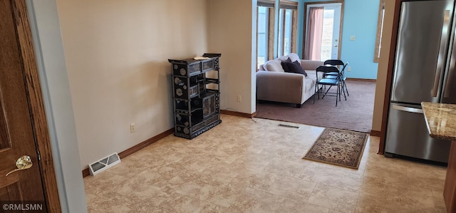 interior space with baseboards and visible vents