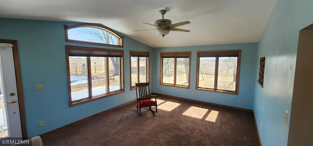 unfurnished sunroom featuring a ceiling fan and vaulted ceiling