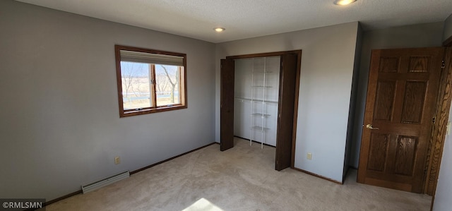 unfurnished bedroom featuring baseboards, visible vents, a closet, a textured ceiling, and light carpet