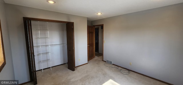 unfurnished bedroom featuring recessed lighting, visible vents, light carpet, and baseboards