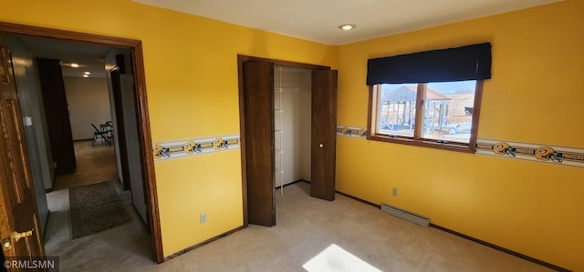 bedroom with baseboards, visible vents, a closet, and light carpet