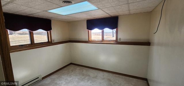 empty room featuring baseboards, carpet, visible vents, and a baseboard radiator