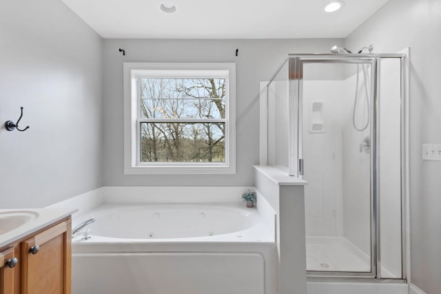 bathroom featuring a jetted tub, vanity, recessed lighting, and a stall shower