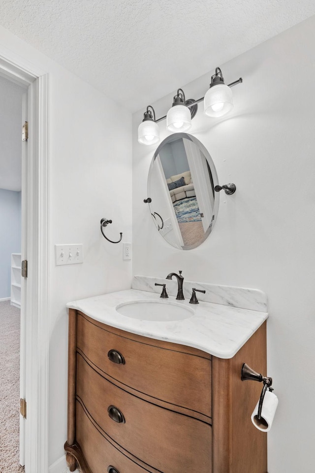 bathroom featuring a textured ceiling and vanity
