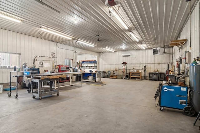 garage featuring a workshop area, a garage door opener, and metal wall