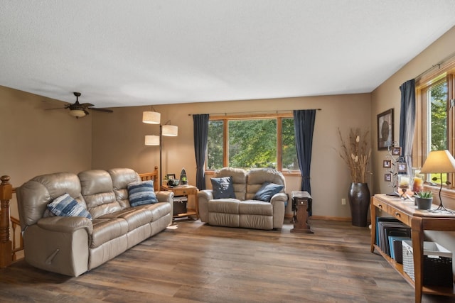 living room featuring a textured ceiling, ceiling fan, and wood finished floors