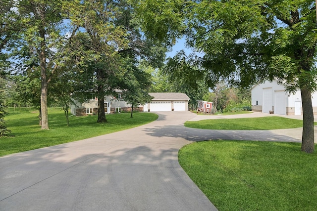 obstructed view of property with a front lawn and driveway