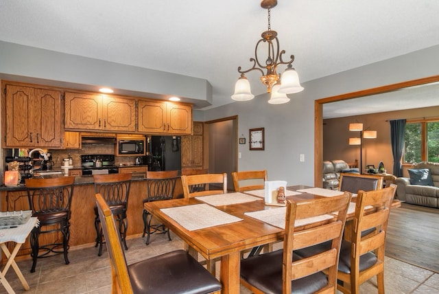 dining room featuring a chandelier and light tile patterned floors