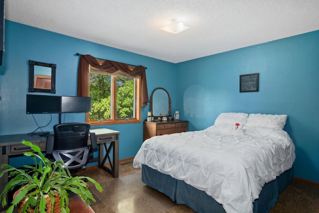 carpeted bedroom featuring a textured ceiling and baseboards