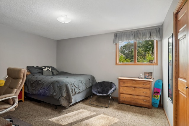 bedroom with light carpet and a textured ceiling
