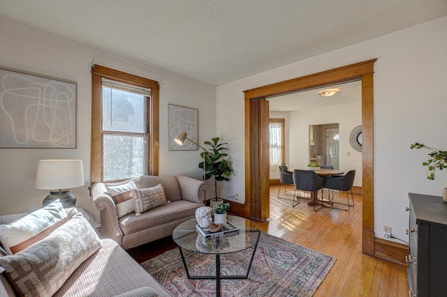 living area with baseboards and light wood-style flooring