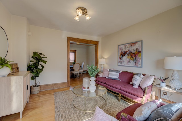 living room featuring baseboards and light wood-style floors