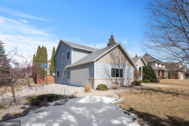 view of home's exterior with a garage, brick siding, and concrete driveway