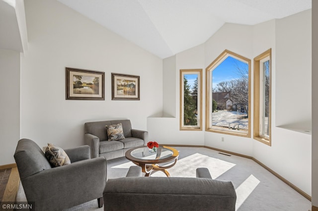 living area with visible vents, lofted ceiling, carpet floors, and baseboards