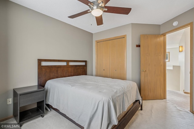 carpeted bedroom featuring baseboards, a closet, and ceiling fan