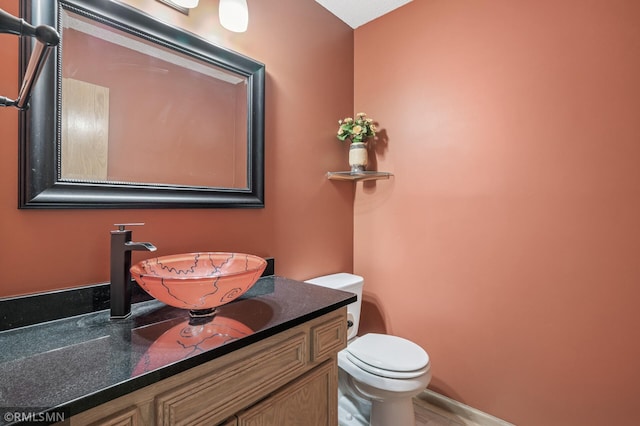 bathroom featuring vanity and toilet