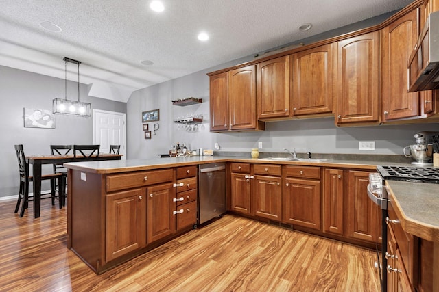 kitchen featuring a peninsula, brown cabinets, and stainless steel appliances