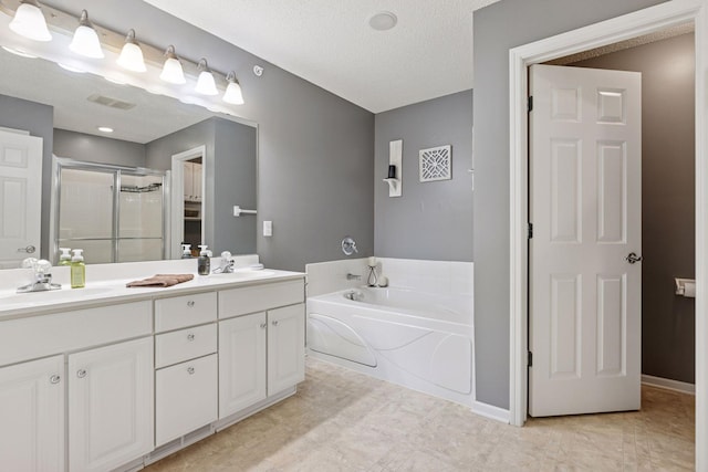 full bathroom featuring a sink, a garden tub, double vanity, and a shower stall