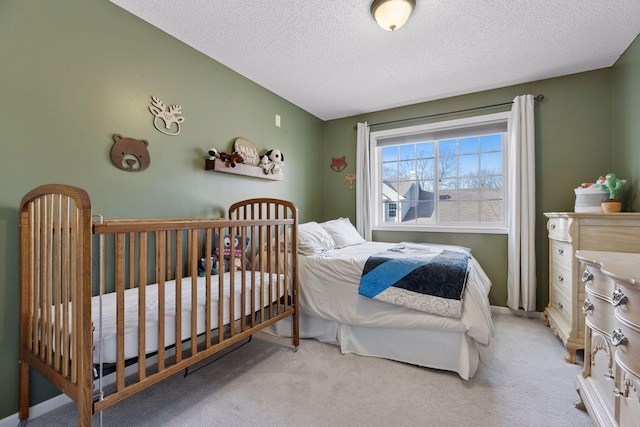 carpeted bedroom featuring a textured ceiling