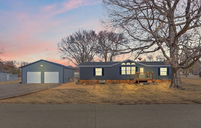 view of front facade featuring a garage and an outdoor structure