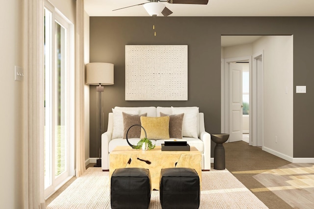 interior space featuring baseboards, carpet, and a ceiling fan