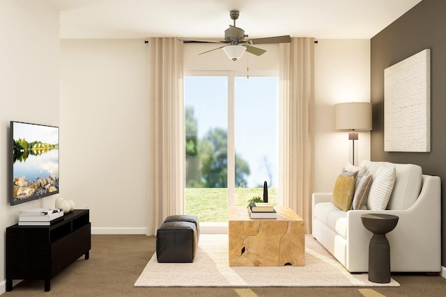 sitting room featuring ceiling fan, baseboards, and carpet