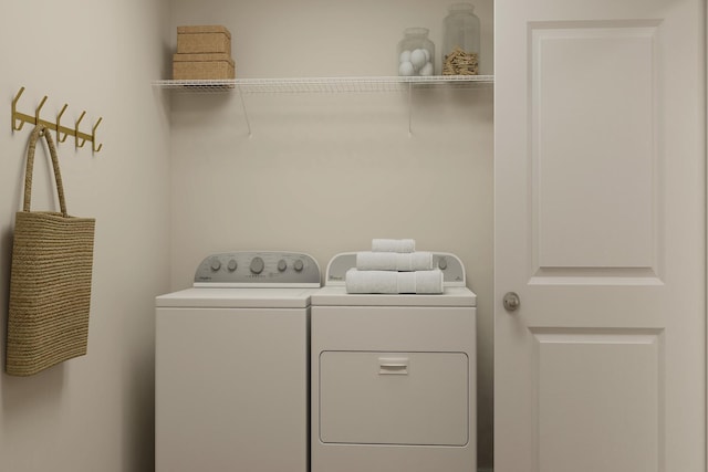 laundry room featuring separate washer and dryer and laundry area