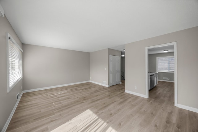 unfurnished bedroom featuring visible vents, baseboards, light wood-style floors, and a closet