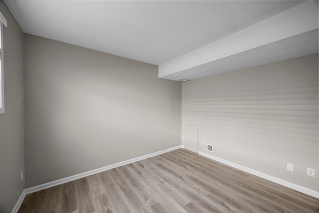 unfurnished room with visible vents, baseboards, and light wood-style floors