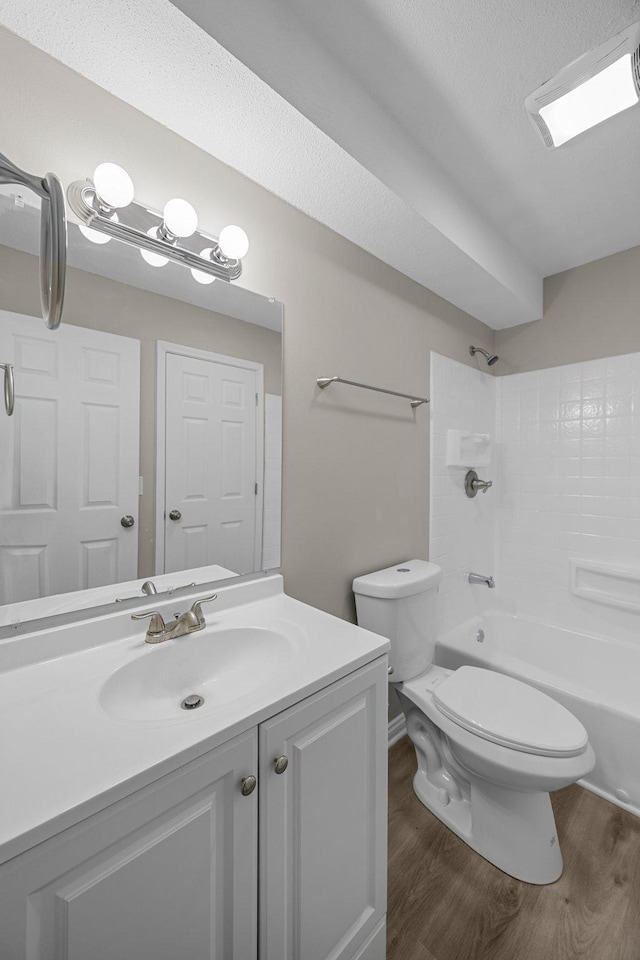 full bath featuring vanity, toilet, shower / bathing tub combination, and wood finished floors