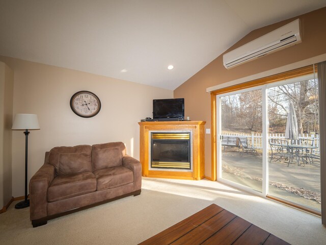 living area featuring carpet, lofted ceiling, a wall unit AC, recessed lighting, and a glass covered fireplace