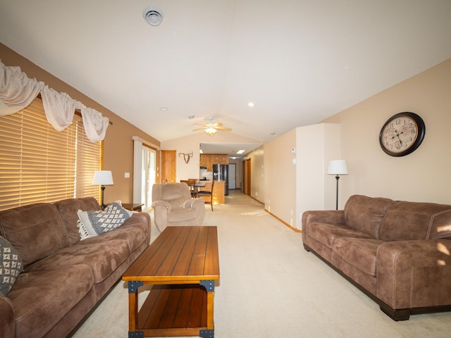 living area featuring visible vents, light colored carpet, a ceiling fan, and vaulted ceiling