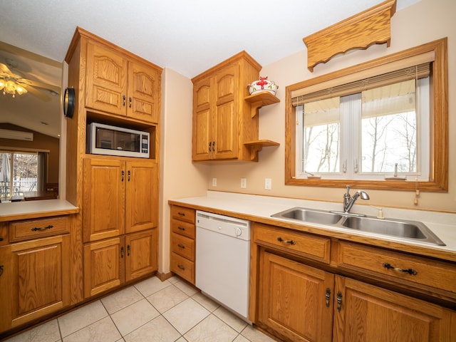 kitchen featuring white appliances, light countertops, and brown cabinets