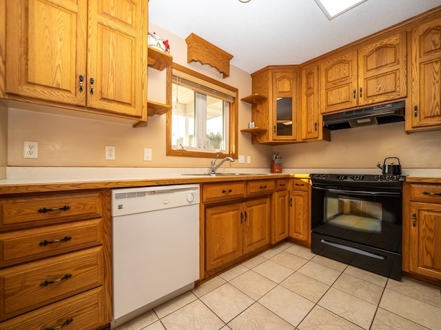 kitchen featuring under cabinet range hood, a sink, black range with electric cooktop, brown cabinetry, and dishwasher