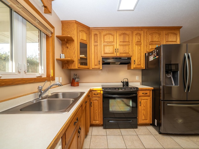 kitchen with stainless steel fridge with ice dispenser, under cabinet range hood, light countertops, black electric range oven, and a sink