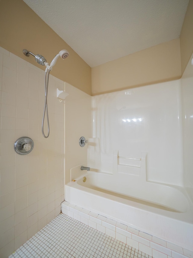 full bathroom featuring tile patterned floors and a textured ceiling