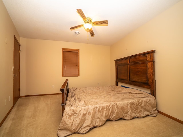 carpeted bedroom with ceiling fan and baseboards