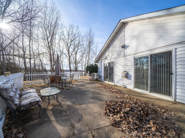 view of patio with outdoor dining area and fence