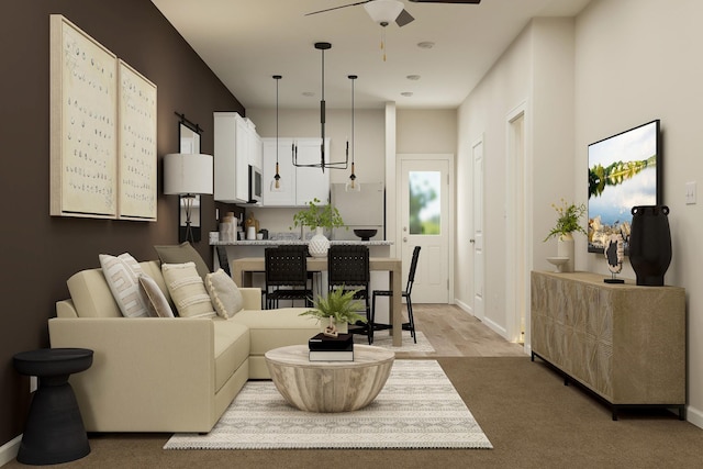 living room with a ceiling fan and baseboards